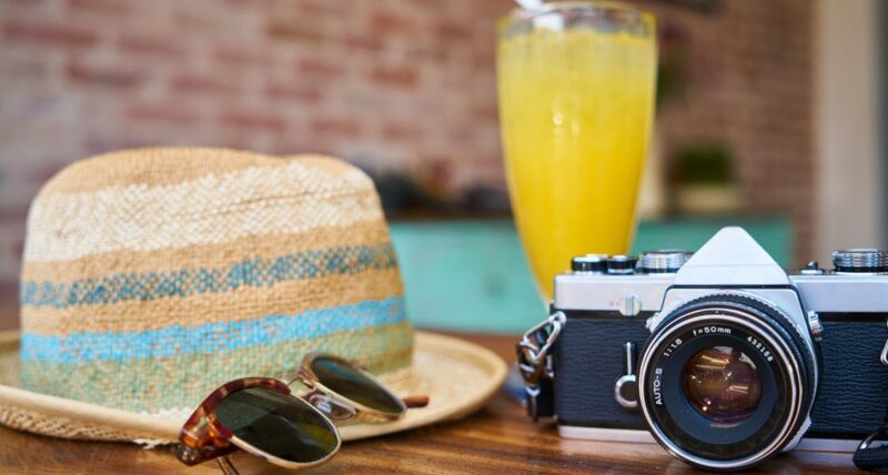 hat sunglasses cocktail camera