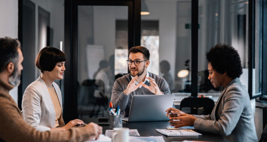 senior-manager-is-sitting-boardroom-with-multiracial-colleagues-discussing-project